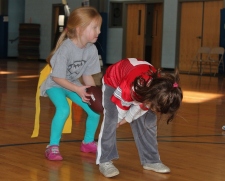 Linnea, 5, hikes the ball to Rhiona, 6, during football practice at the Pigskin Princess Project.  Permission granted from all parents to use photos. 